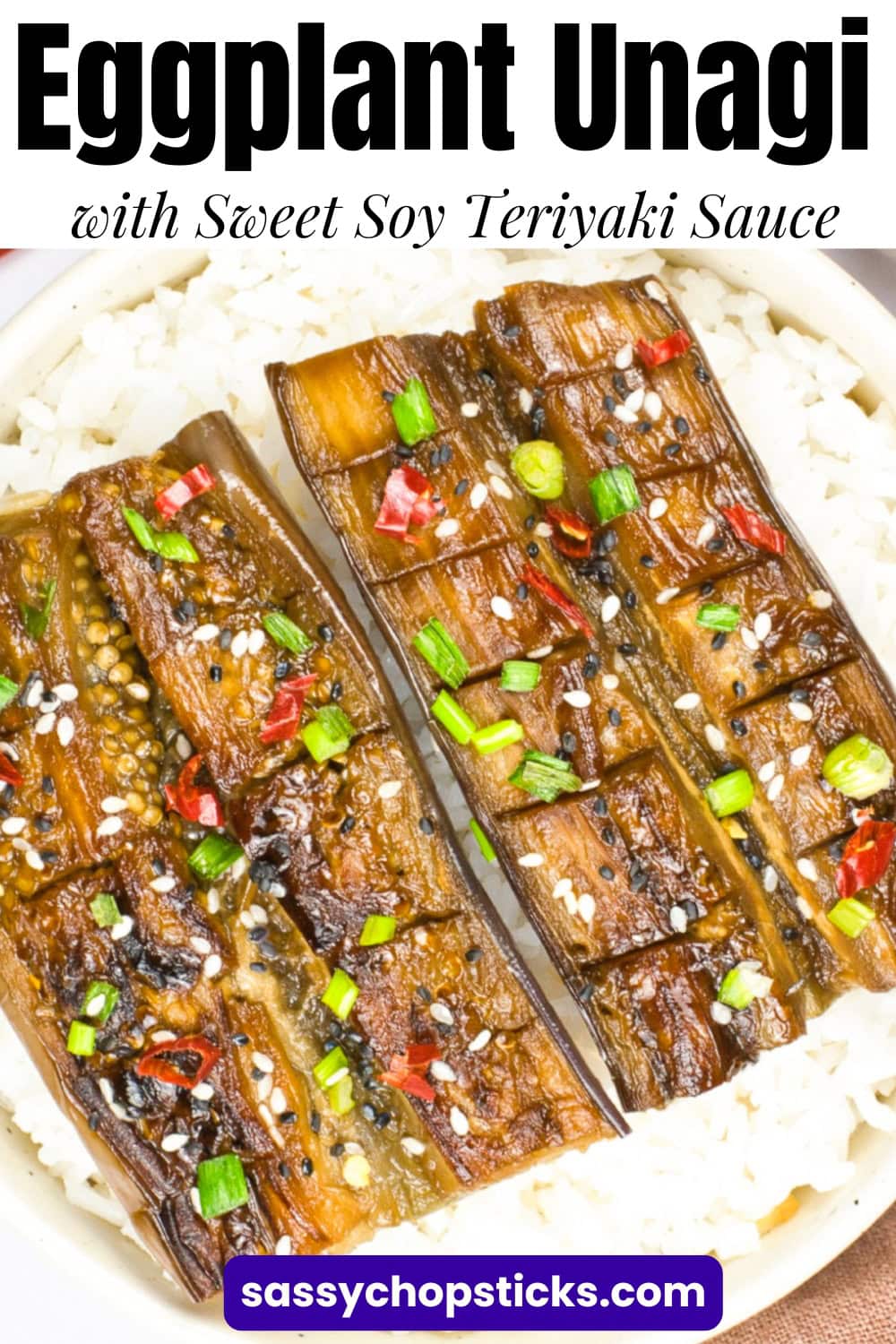 Glazed Japanese-style eggplant scored and served over white rice with sesame seeds and green onions.