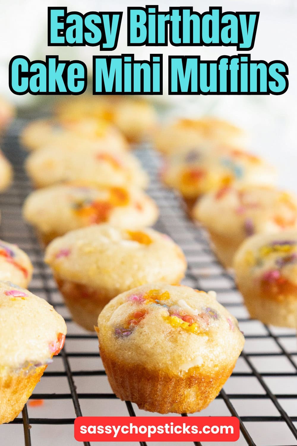 Birthday cake mini muffins with rainbow sprinkles are cooling on a rack.
