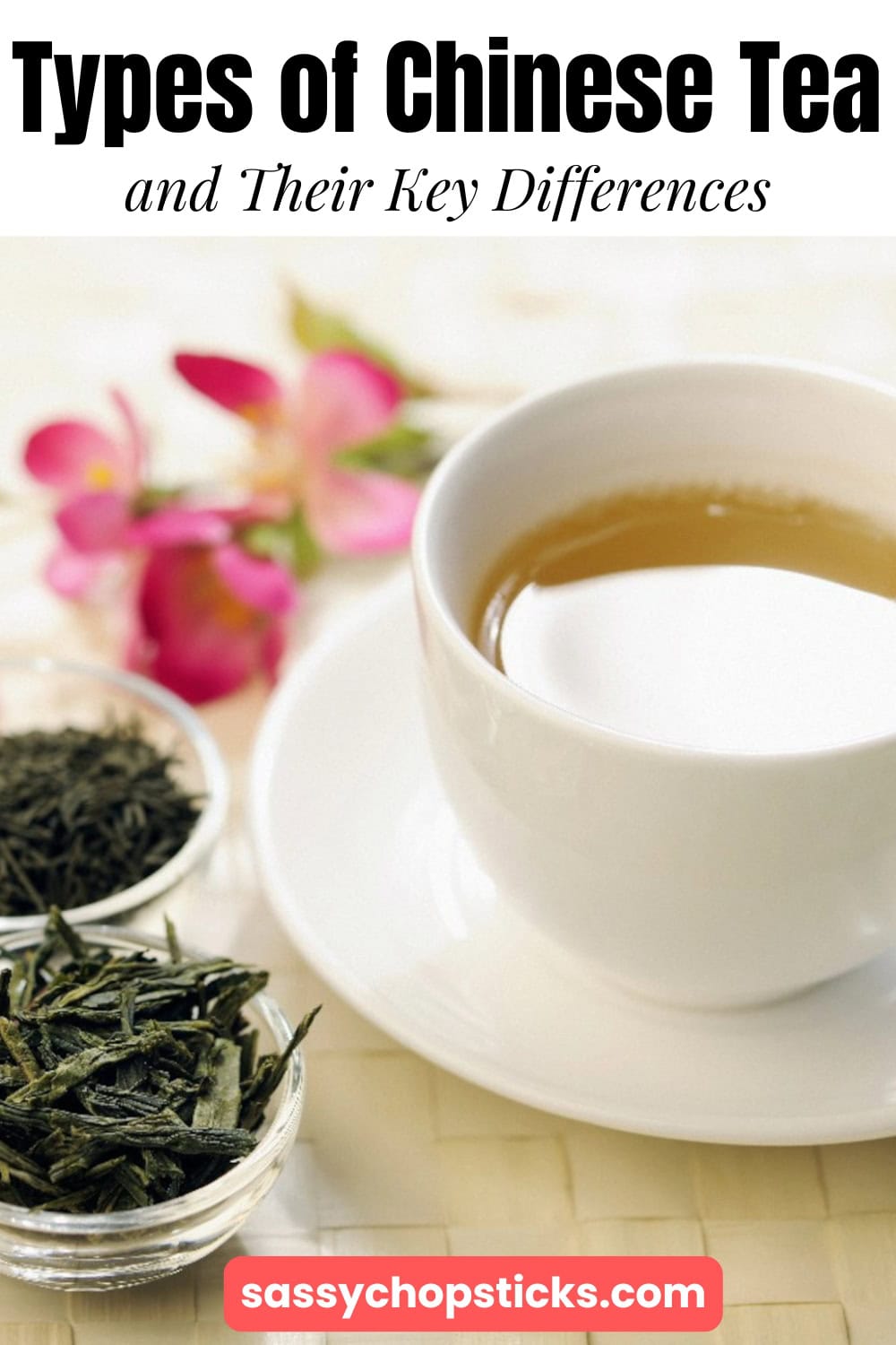 Green tea leaves beside a cup of Chinese tea with flowers in the background.