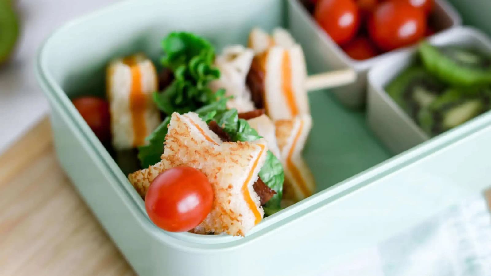 Turkey kabobs layered with bacon, grilled cheese pieces, and vegetables.