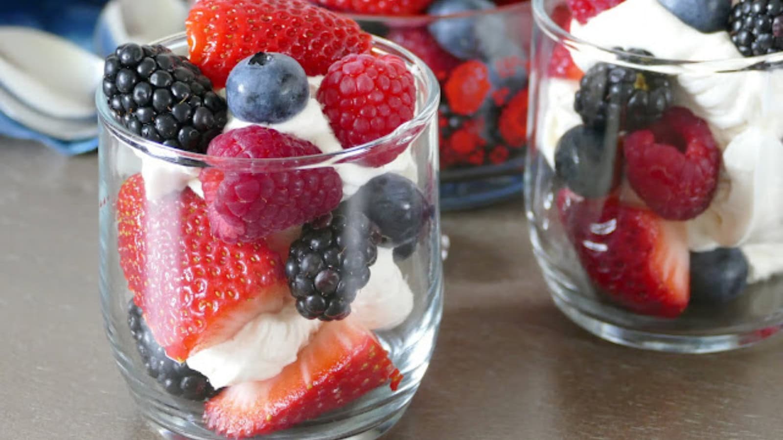 Fresh berries served with a creamy topping for a patriotic dessert.