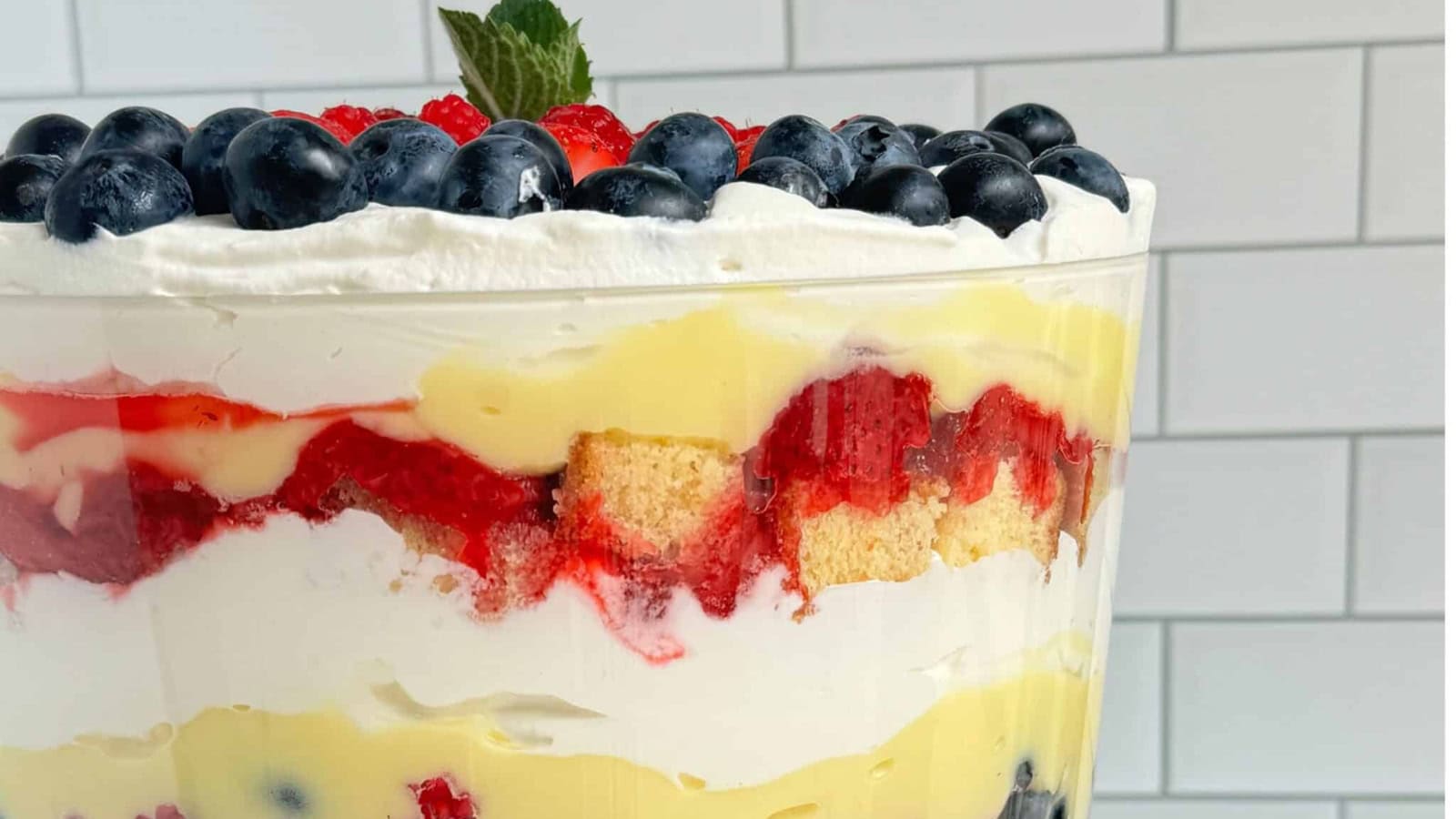 Patriotic berry trifle layered with fresh berries, cream, and cake.