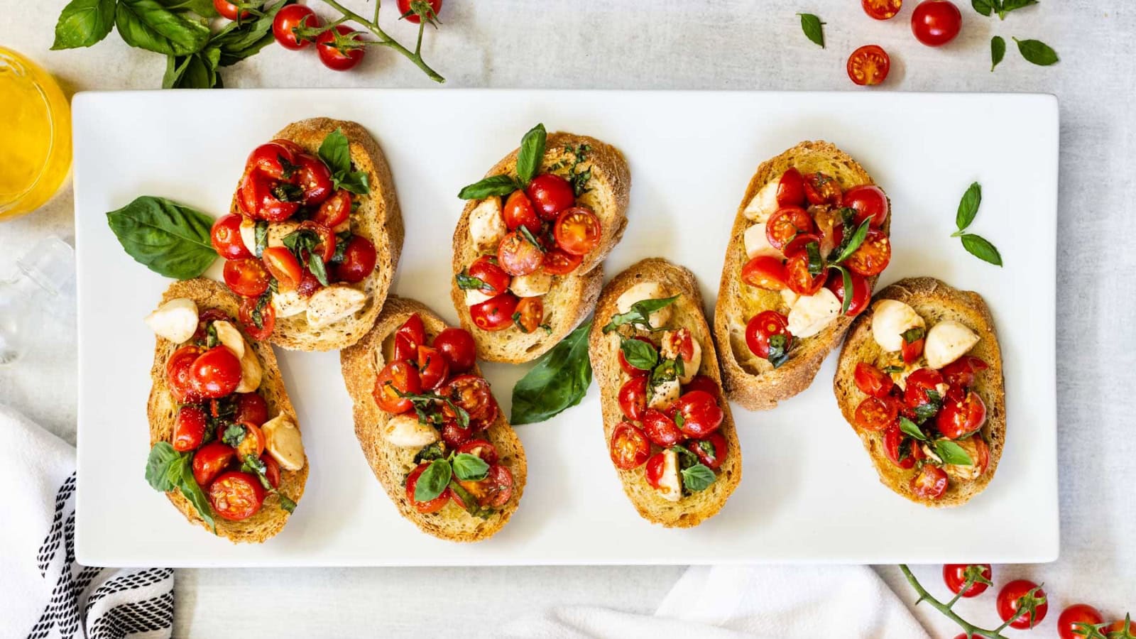 Toasted bruschetta topped with tomatoes, mozzarella, and fresh basil.