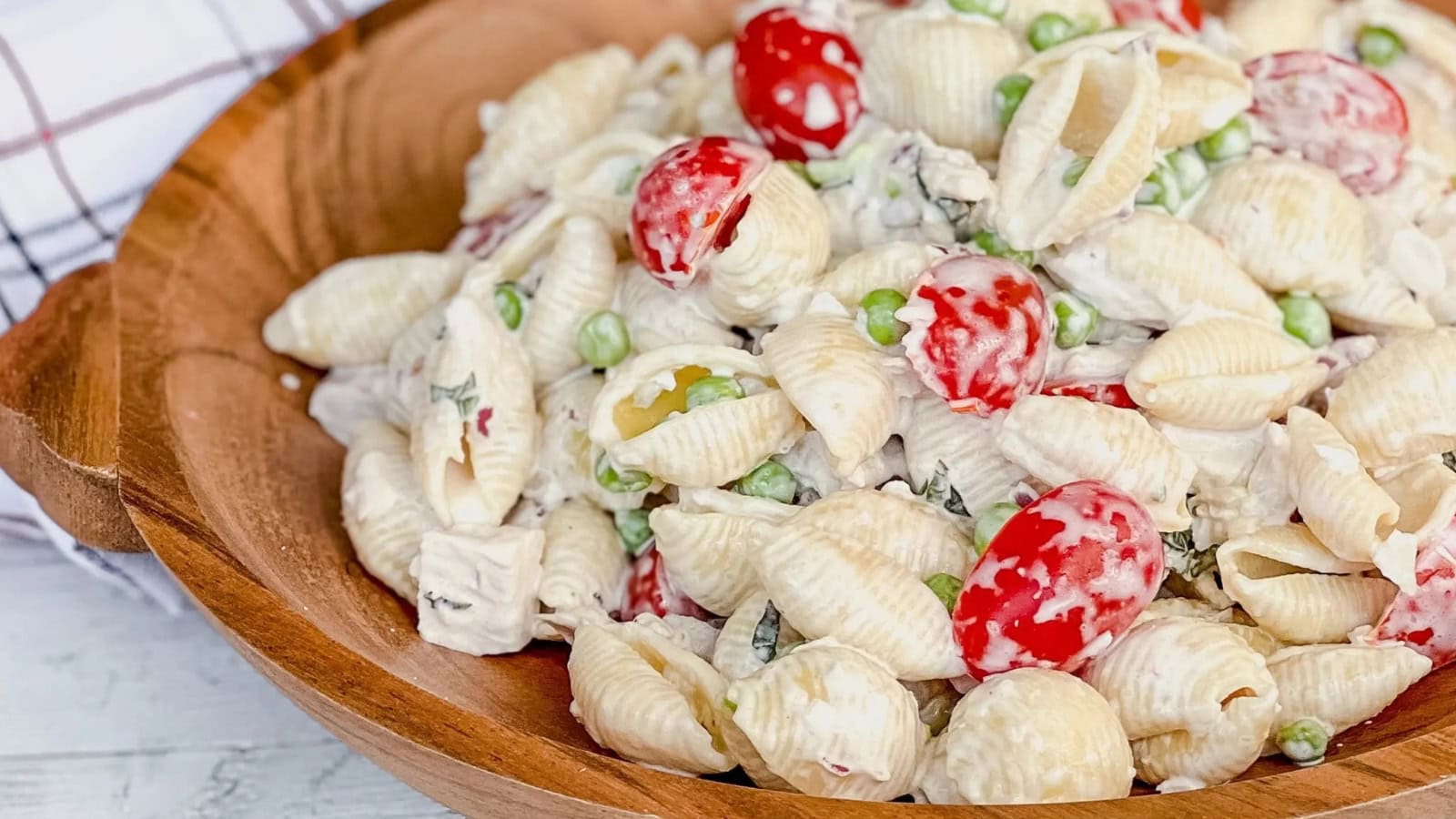 Cold chicken pasta salad mixed with vegetables and a creamy dressing.