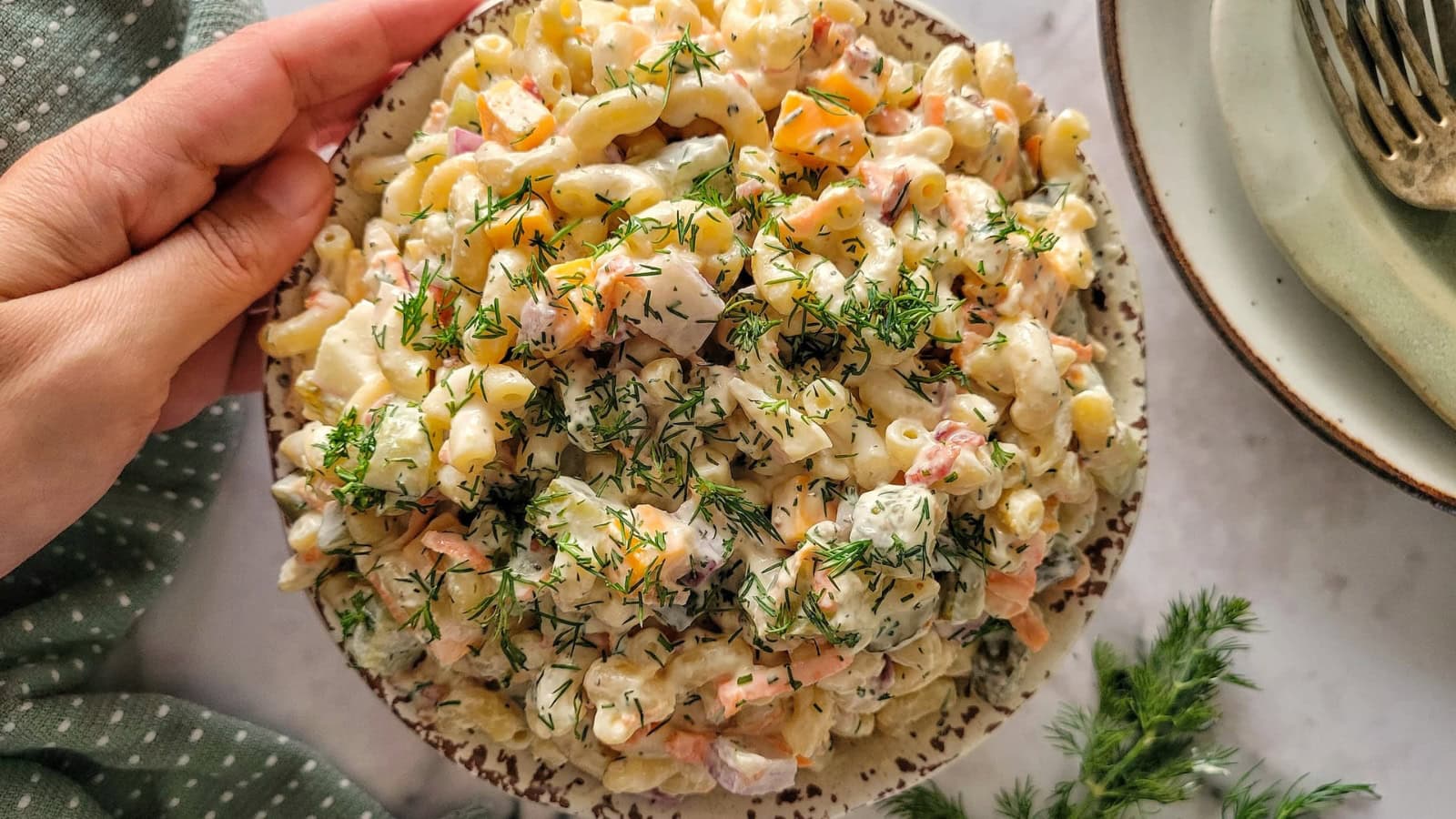 Pasta salad mixed with dill pickles and creamy tangy dressing.