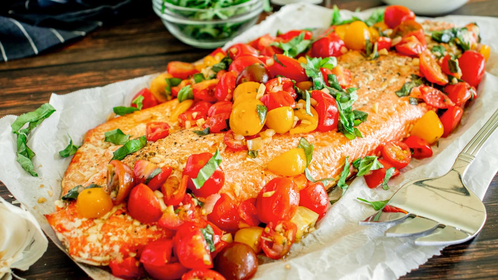 Salmon fillets topped with fresh bruschetta tomatoes and herbs.