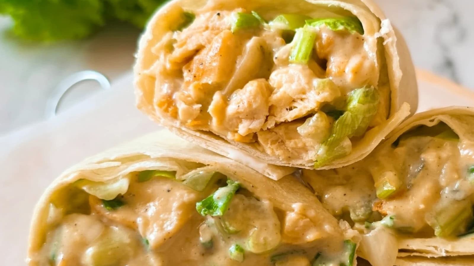 Wrap filled with chicken salad and crisp vegetables.