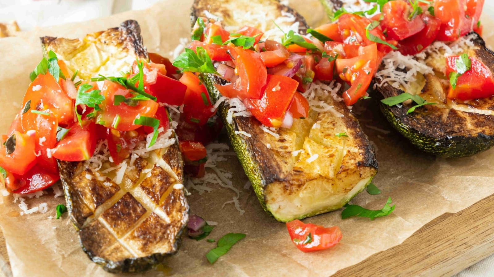 Baked zucchini and cherry tomatoes seasoned with Mediterranean herbs.