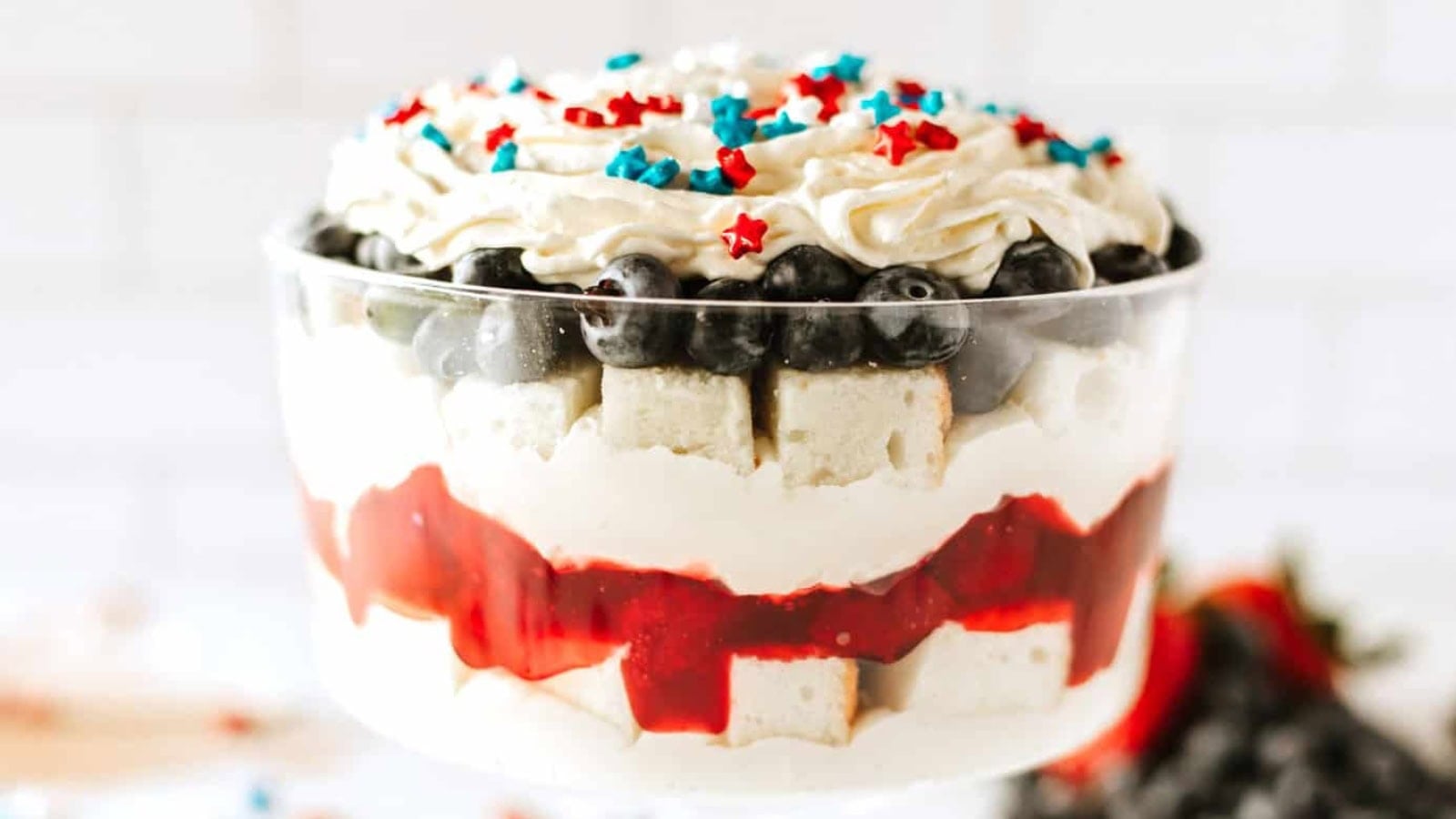 Patriotic trifle layered with cake, whipped cream, and fresh berries.