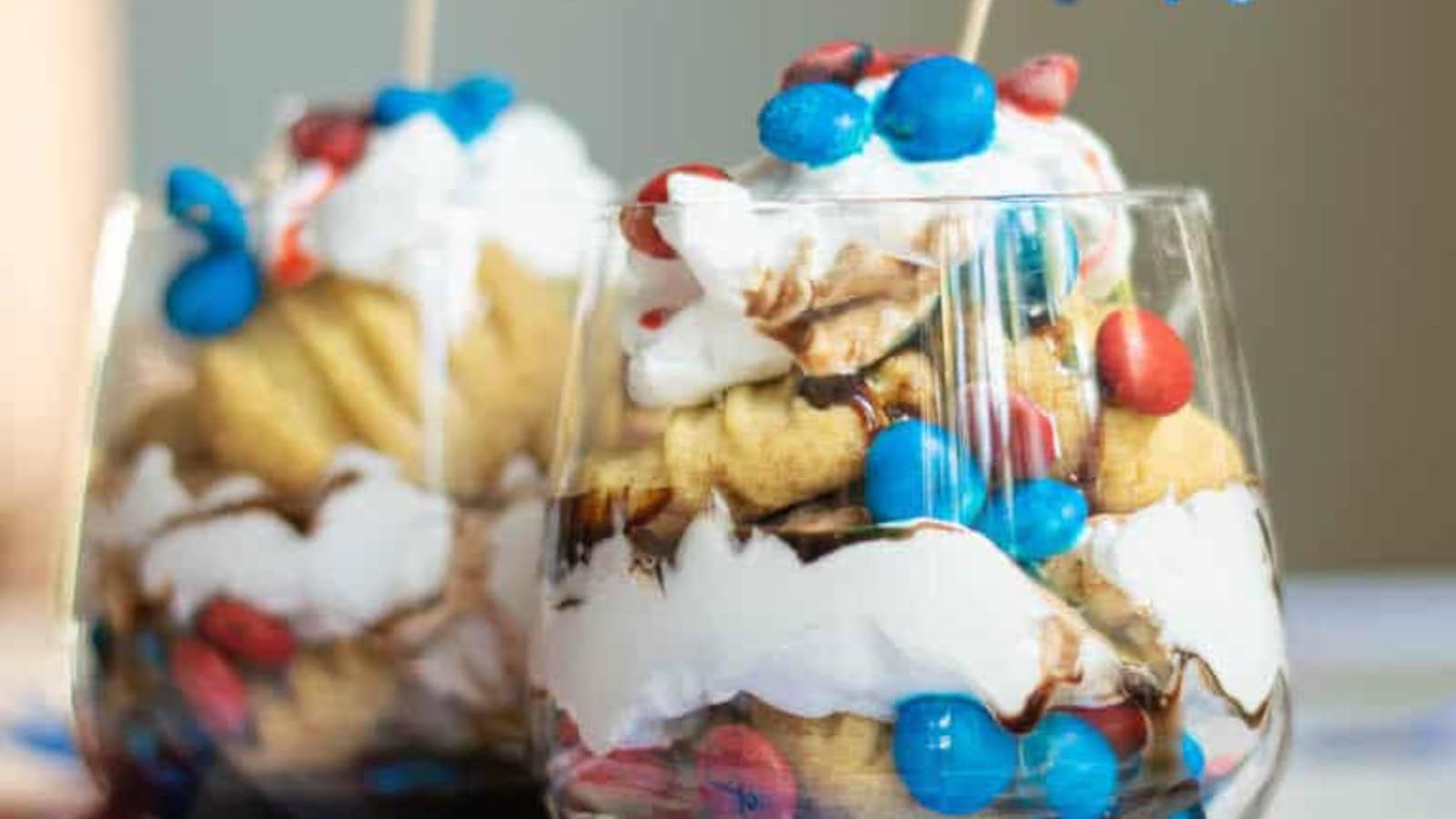 Layered patriotic trifle with berries, cake, and fluffy whipped cream.