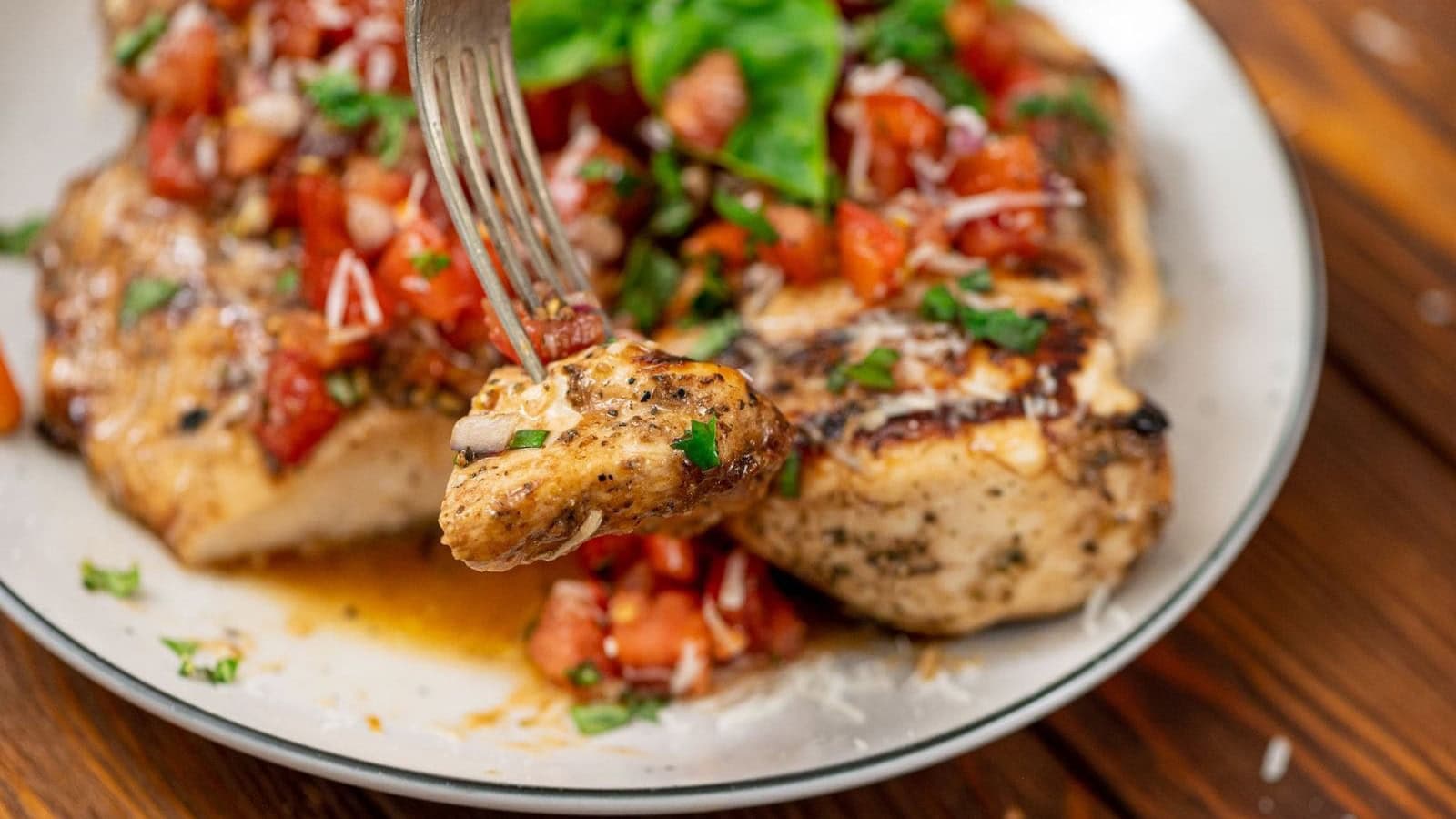 Grilled chicken breasts topped with a fresh tomato bruschetta mixture.