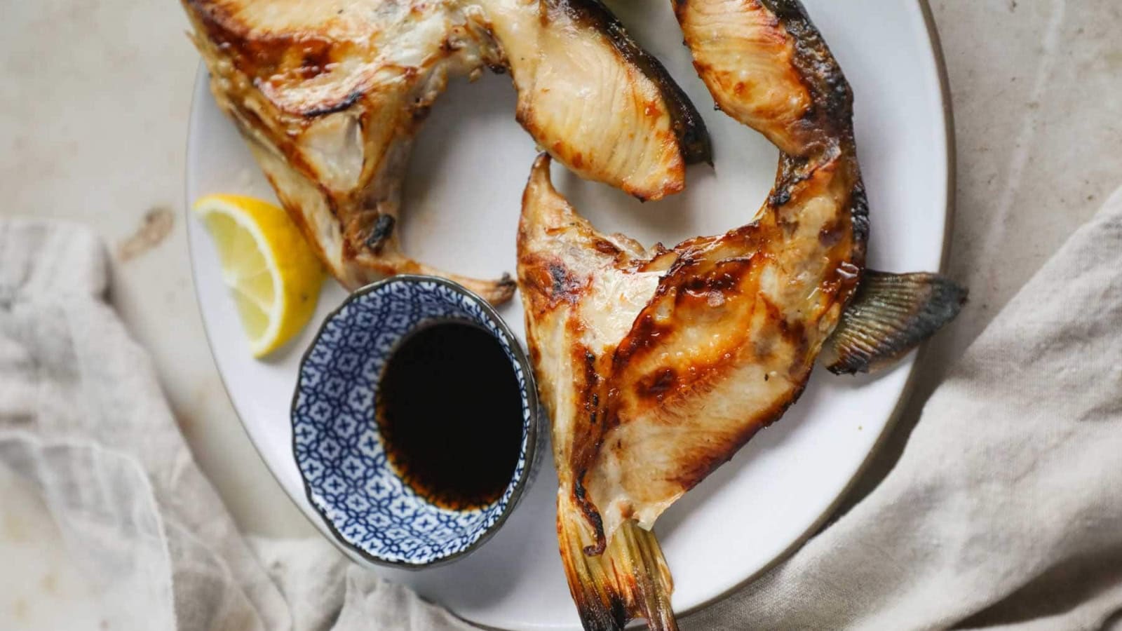 Grilled yellowtail collar cooked until tender with crispy edges.
