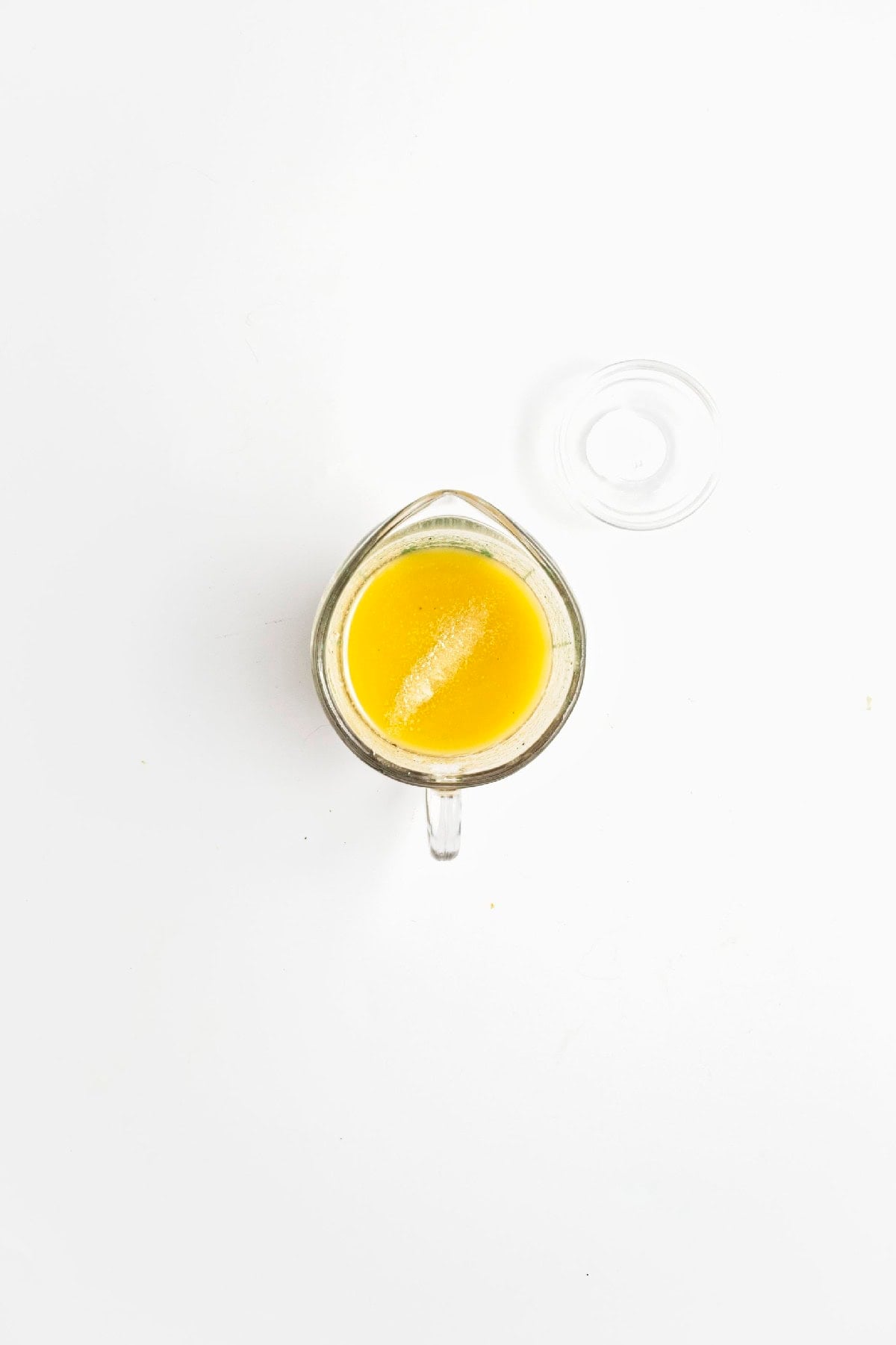Smooth lemon miso dressing mixed in a glass measuring cup.