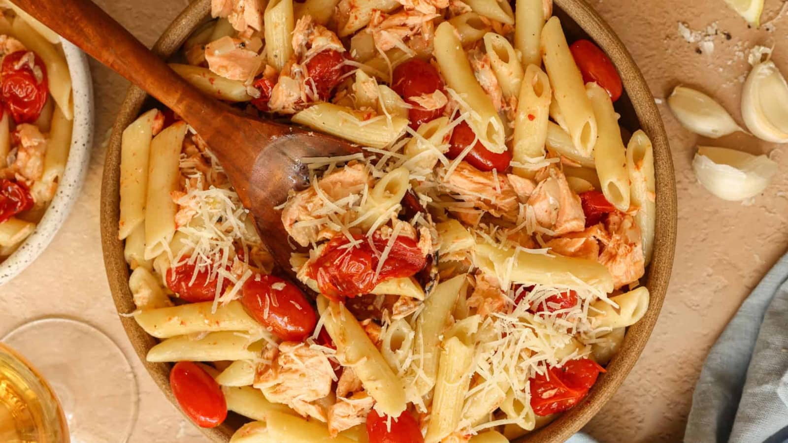 Salmon pasta with tomatoes and herbs in a light sauce.