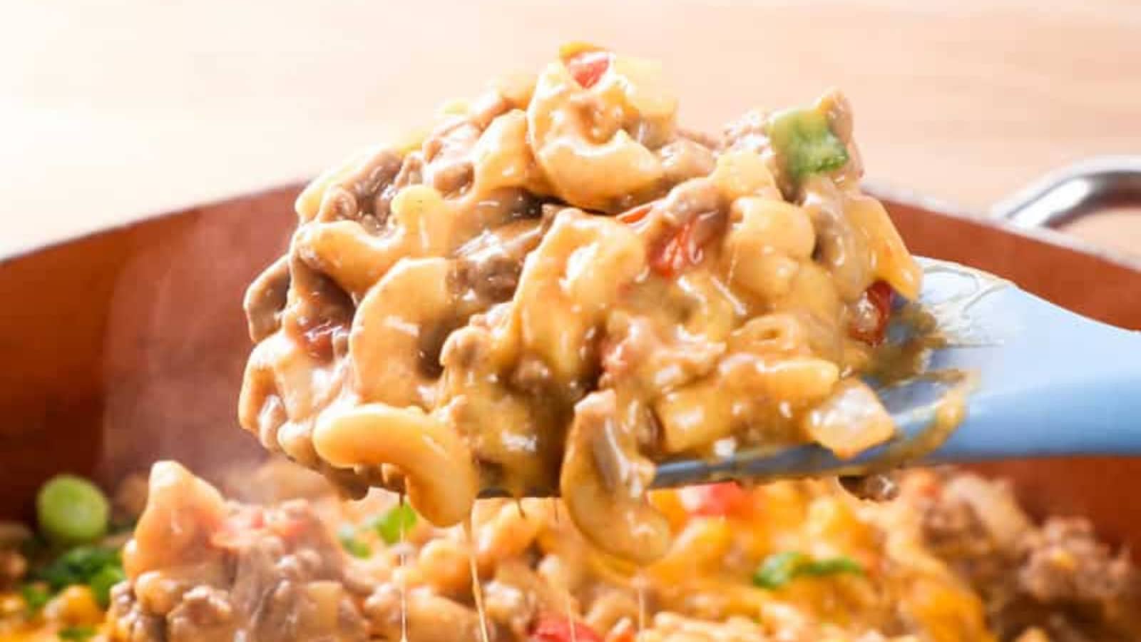 Cheesy taco pasta cooked in one pot with seasoned meat and tomatoes.