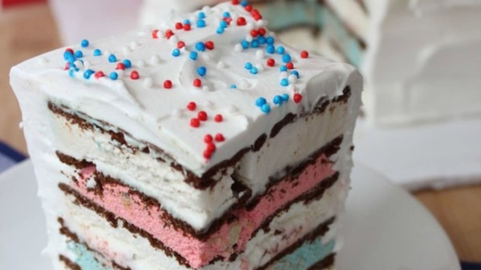 Patriotic ice cream cake decorated with colorful layers and festive toppings.