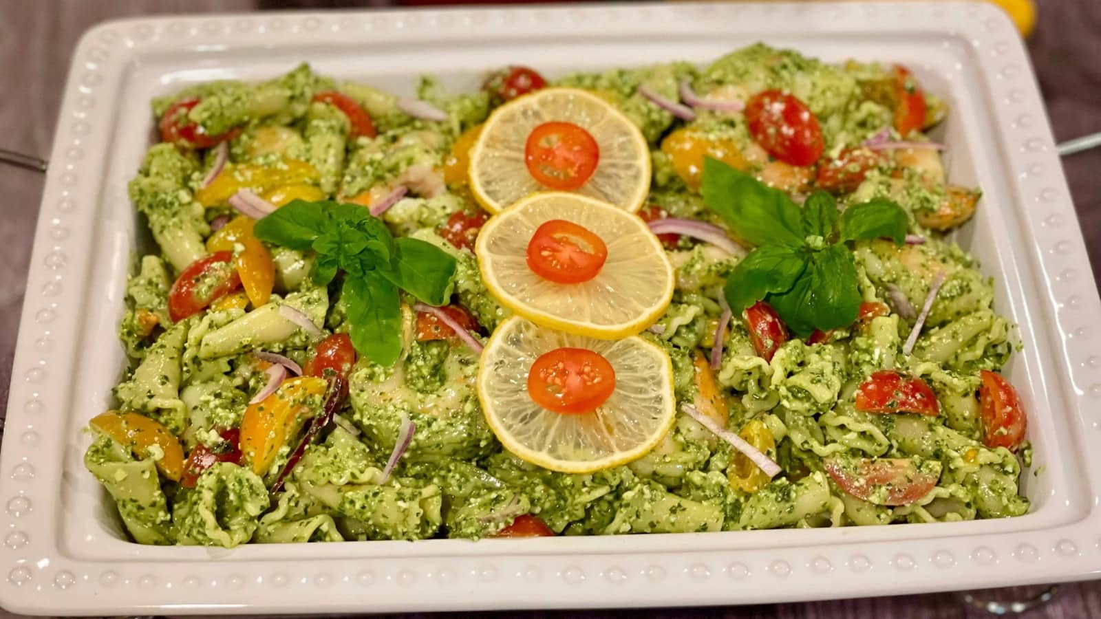 Shrimp pasta salad tossed with pesto and fresh vegetables.