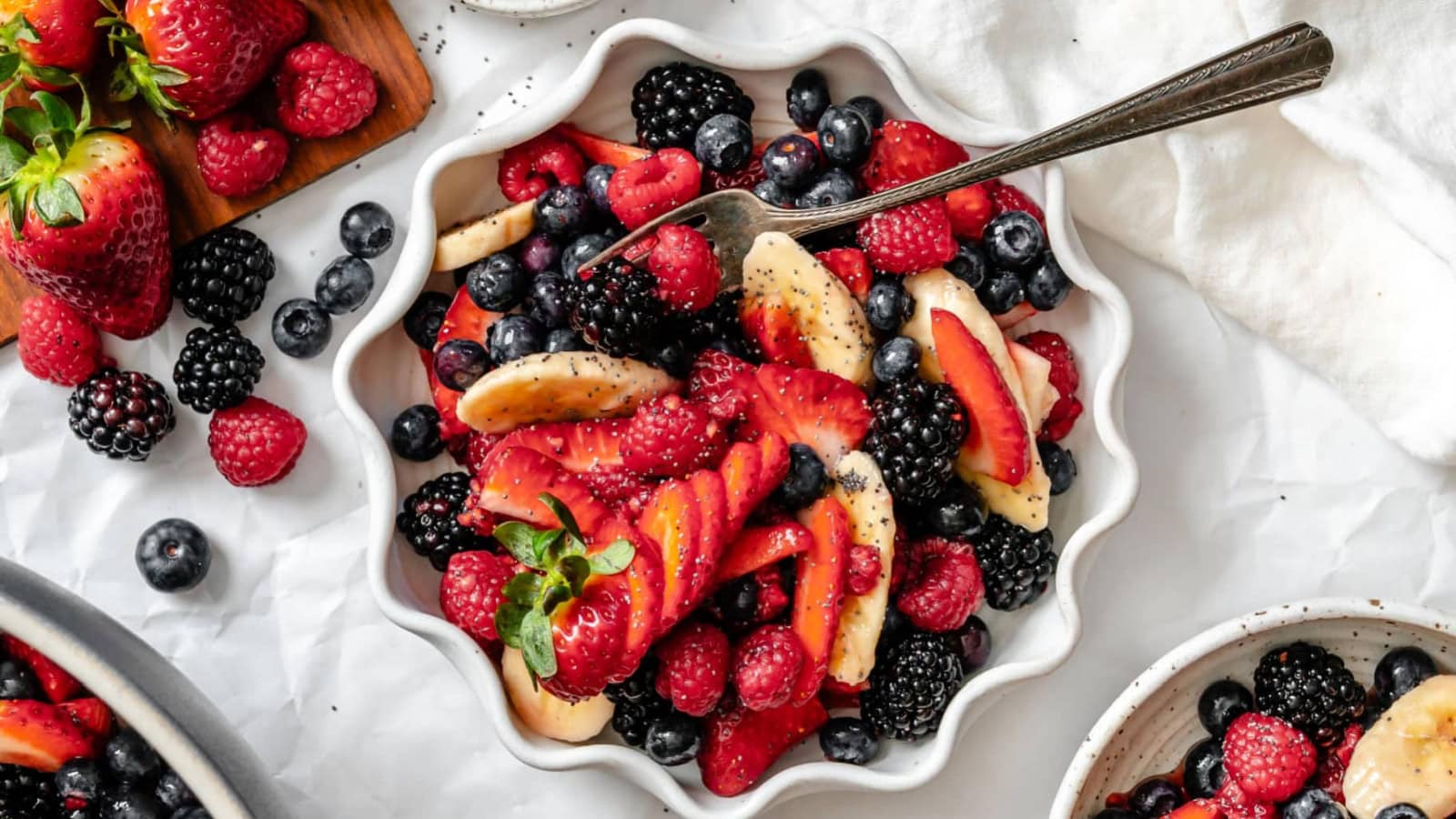 Fruit salad mixed with fresh fruit and poppy seed dressing.