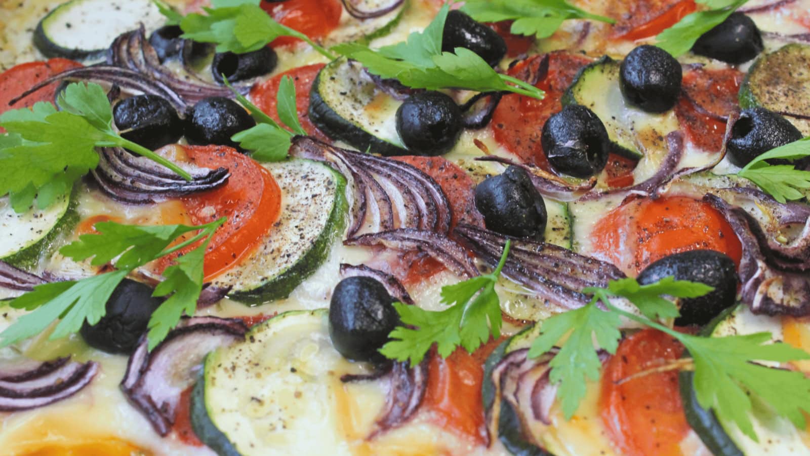 Puff pastry tart topped with zucchini, tomatoes, and creamy ricotta cheese.