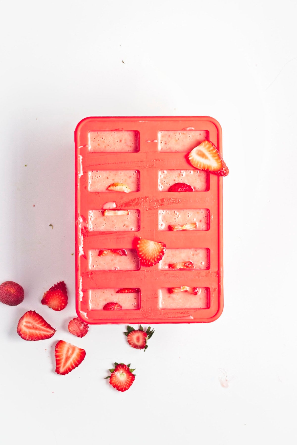 Pour the strawberry popsicle mixture into a silicone popsicle mold.