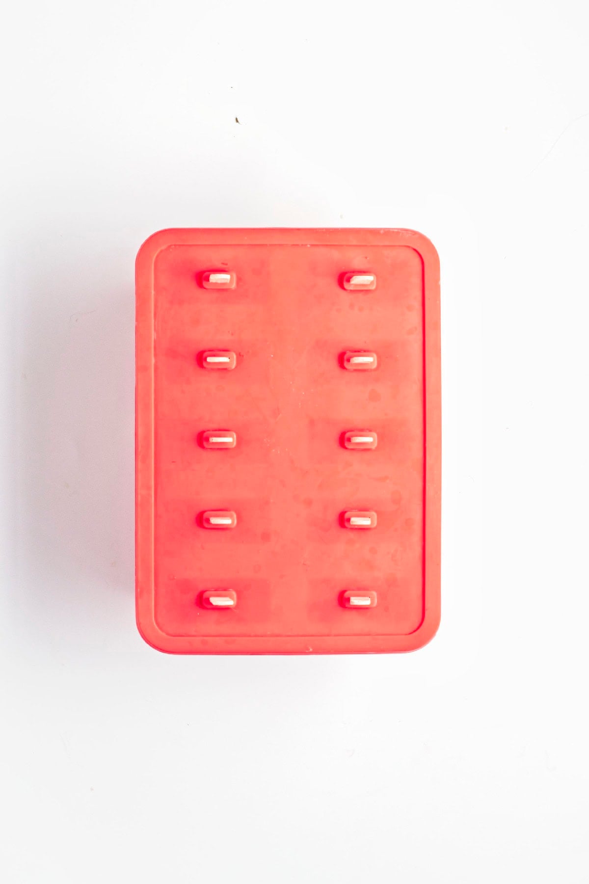 Fresh strawberry slices added to each popsicle mold for extra fruit.