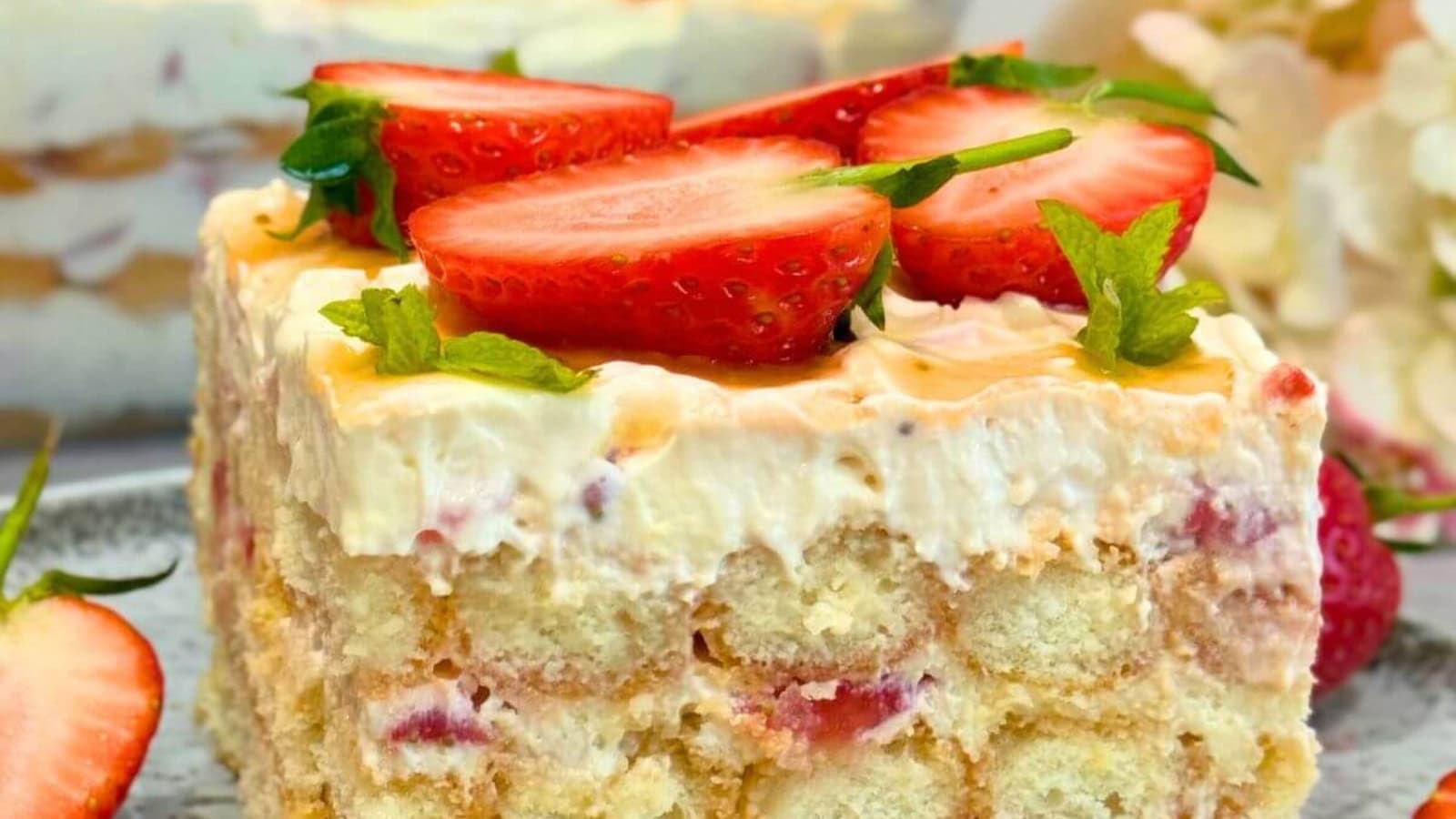 Strawberry tiramisu layered with cream and fresh strawberries.