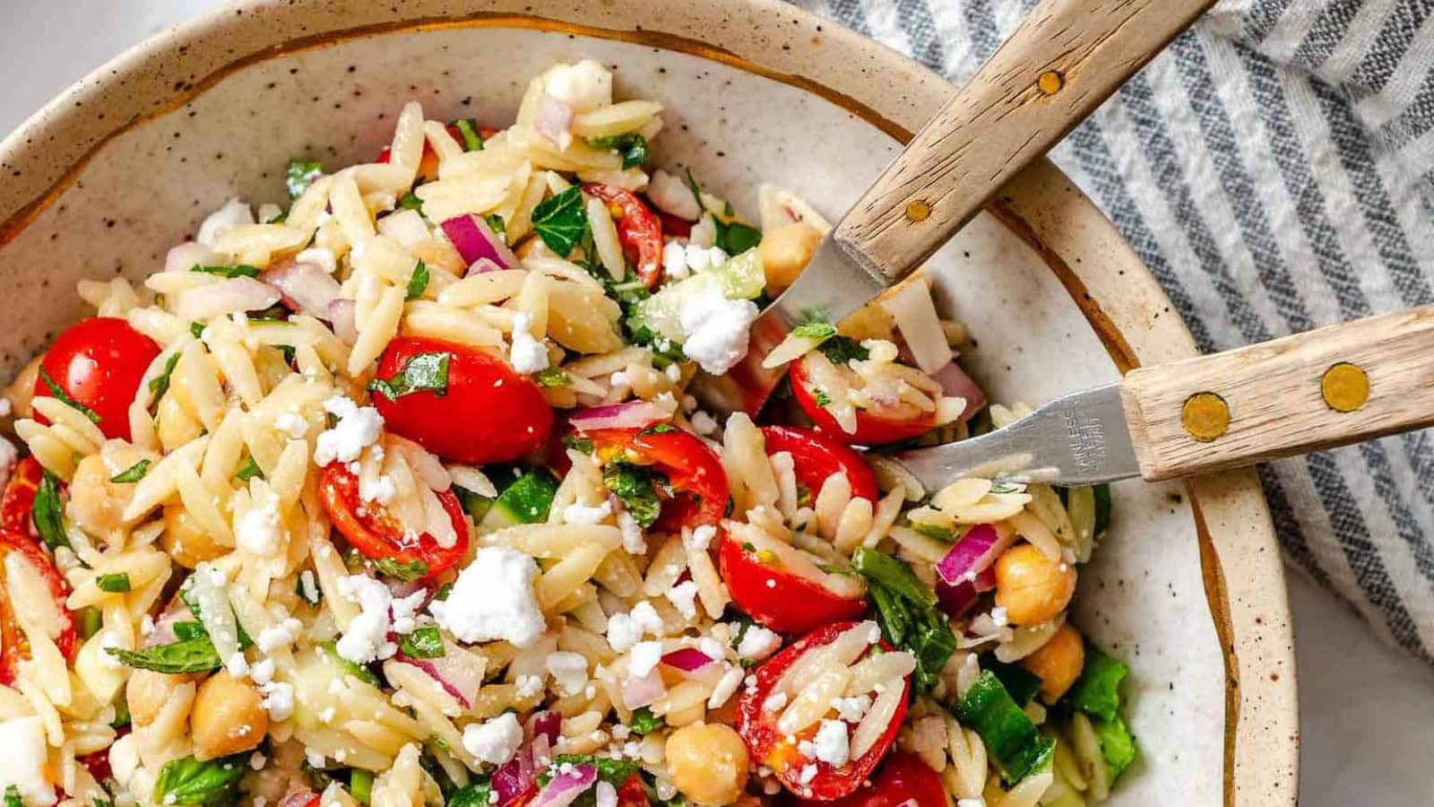 Orzo pasta salad tossed with summer vegetables and herbs.