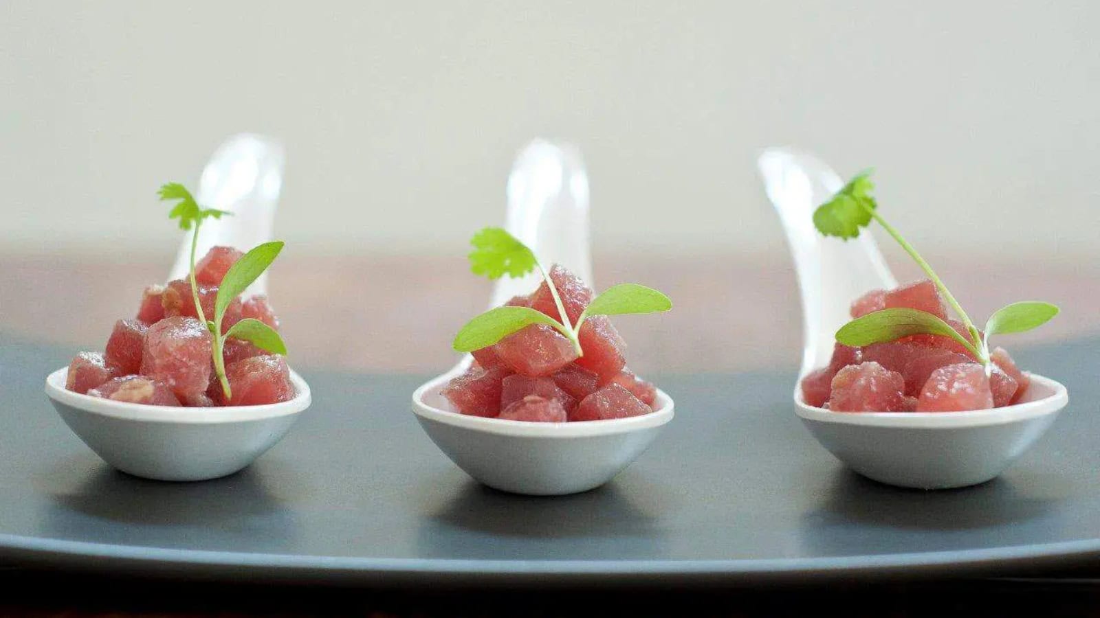 Fresh tuna sashimi drizzled with yuzu dressing and garnished with baby coriander.