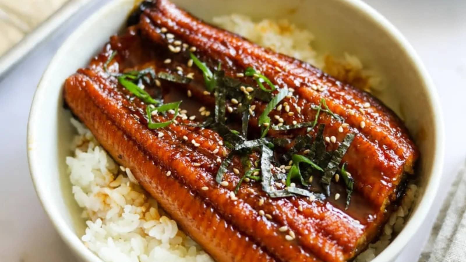 Grilled eel served over steamed rice with a savory glazed sauce.