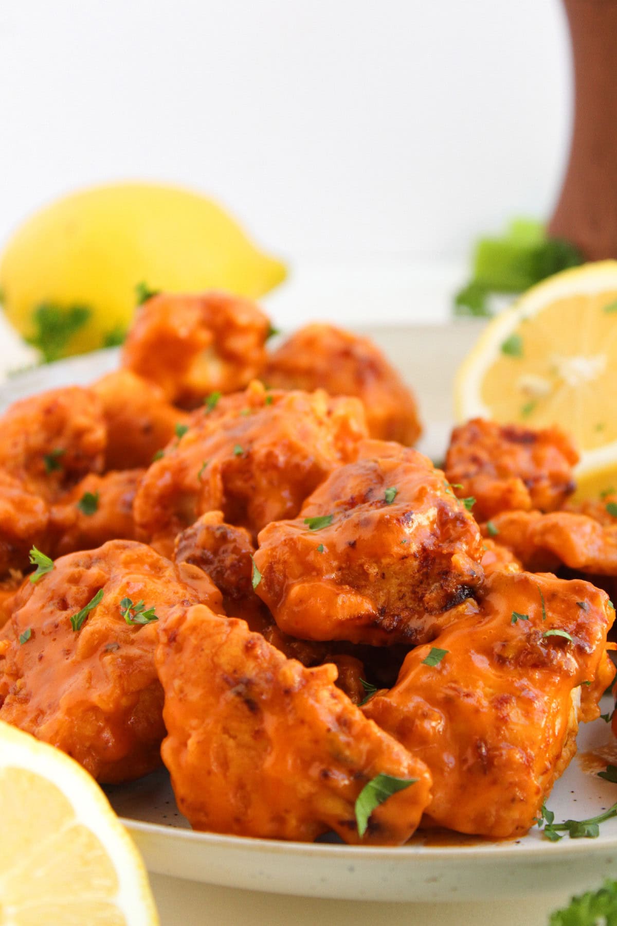 Close-up of crispy boneless buffalo wings coated in spicy buffalo sauce.