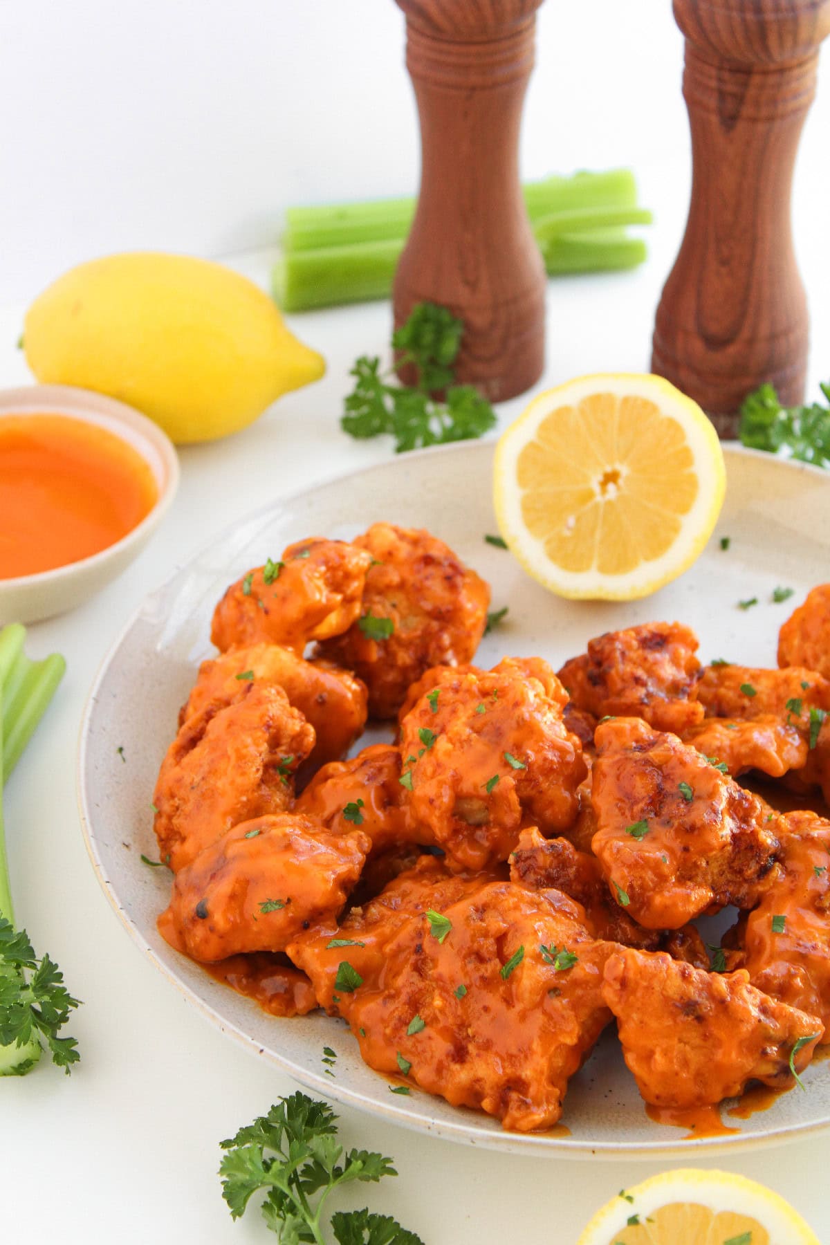 Close-up of boneless buffalo wings with a fork showing the tender chicken inside.