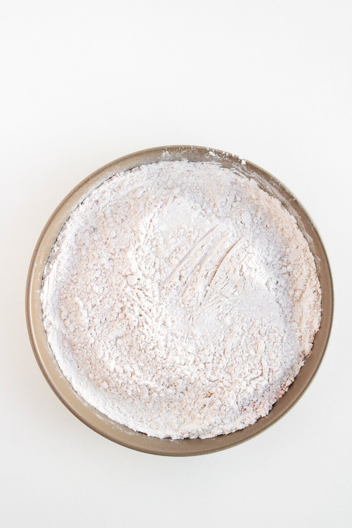 Seasoned flour mixture prepared for coating boneless buffalo wings.