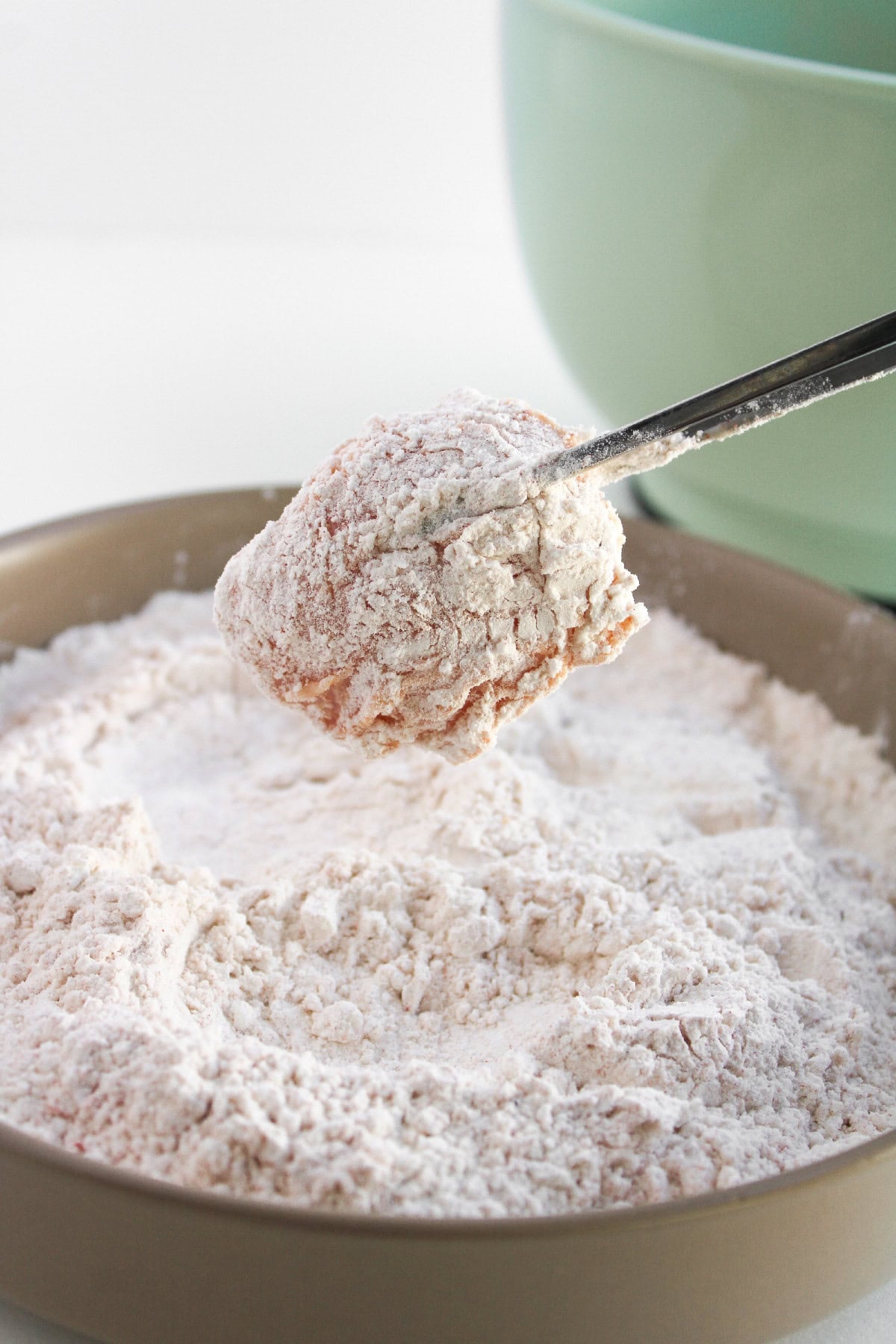 Marinated chicken piece coated in seasoned flour for crispy boneless buffalo wings.