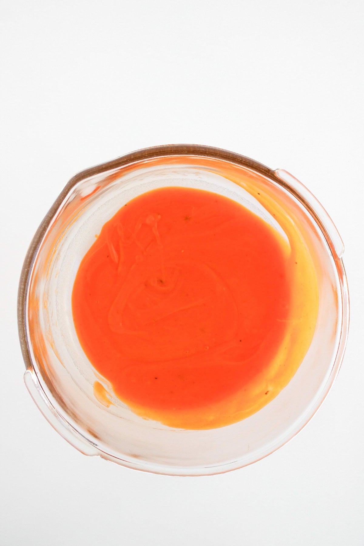 Buffalo sauce mixture prepared for coating boneless buffalo wings.