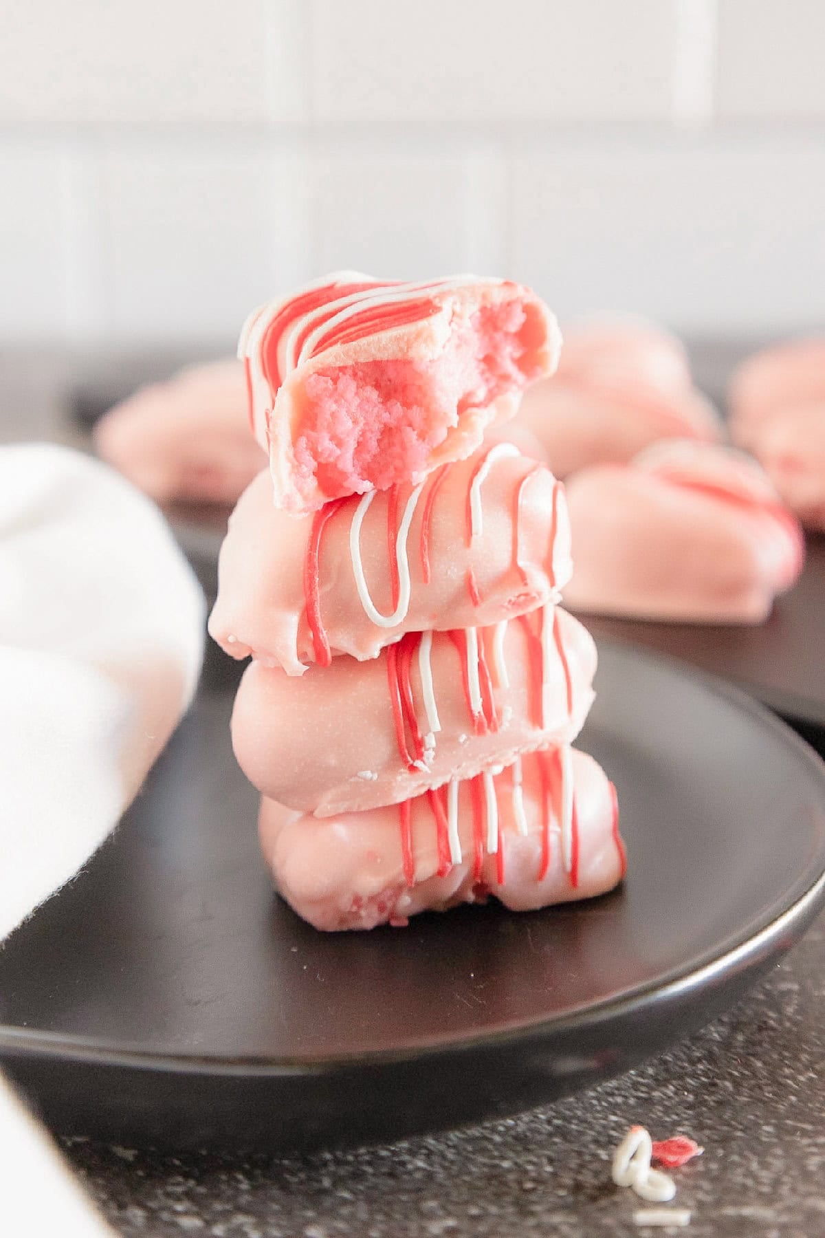 Bitten pink cake truffle showing a moist cake center inside a candy coating.