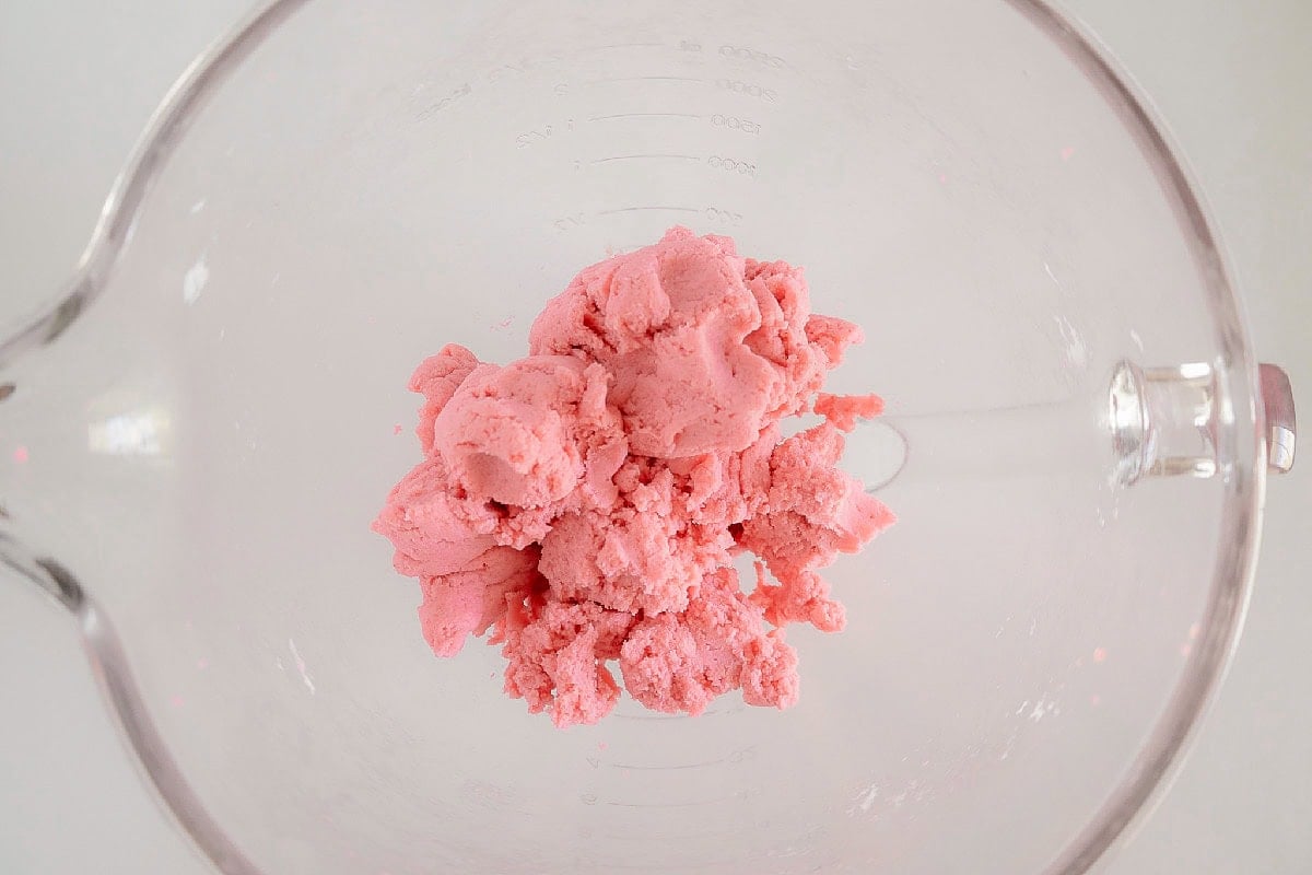 Pink cake and cream cheese mixture blended into a smooth dough.