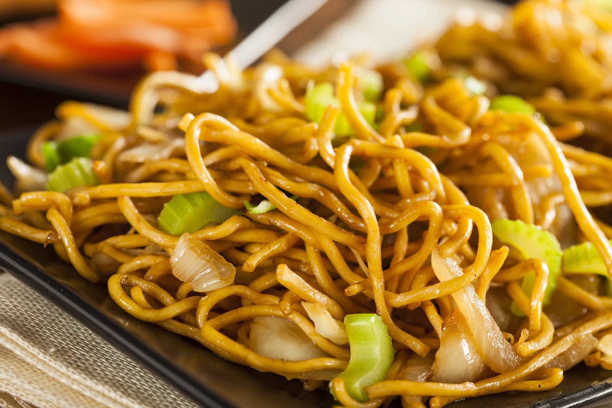 Chow mein noodles stir-fried with cabbage and celery on a plate.