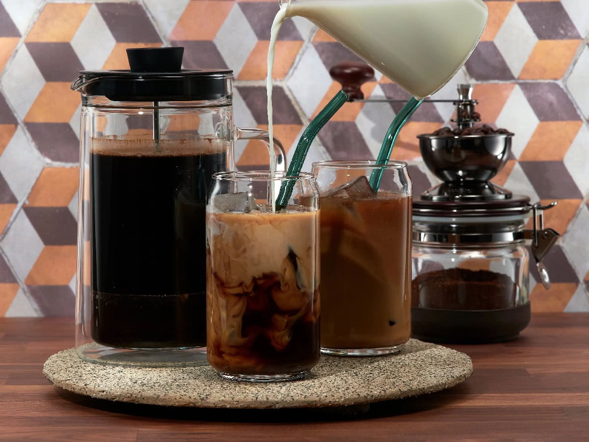Homemade cold brew coffee with milk and a French press.