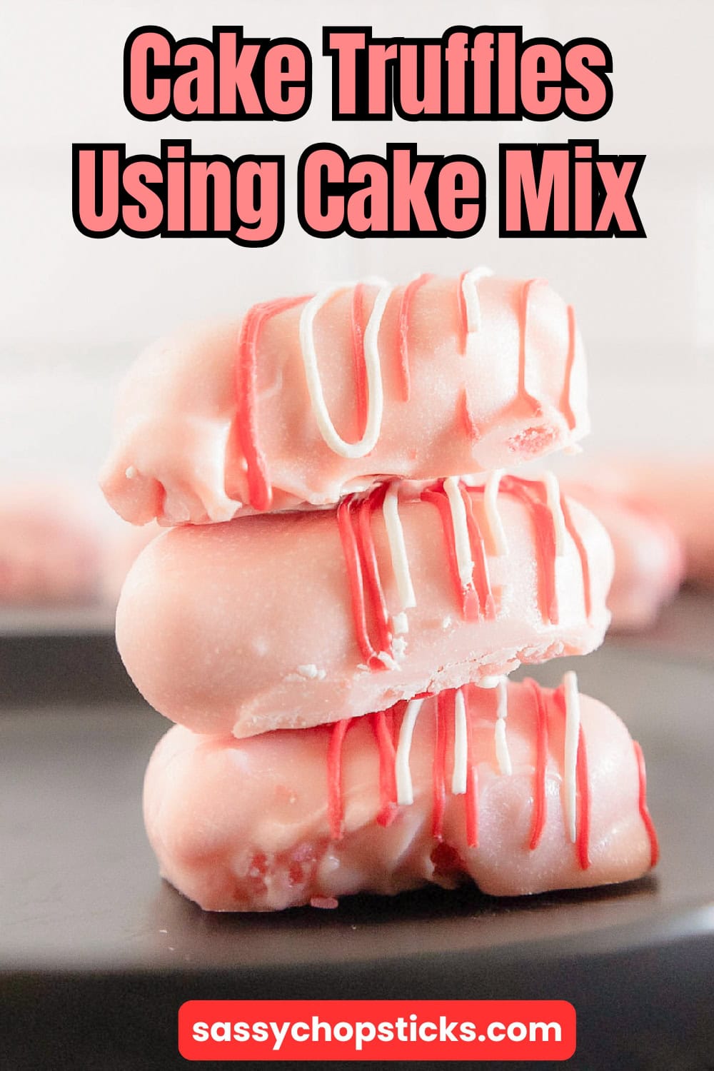 Cake truffles made with cake mix, featuring a stack of pink cake truffles with pink and white drizzle.