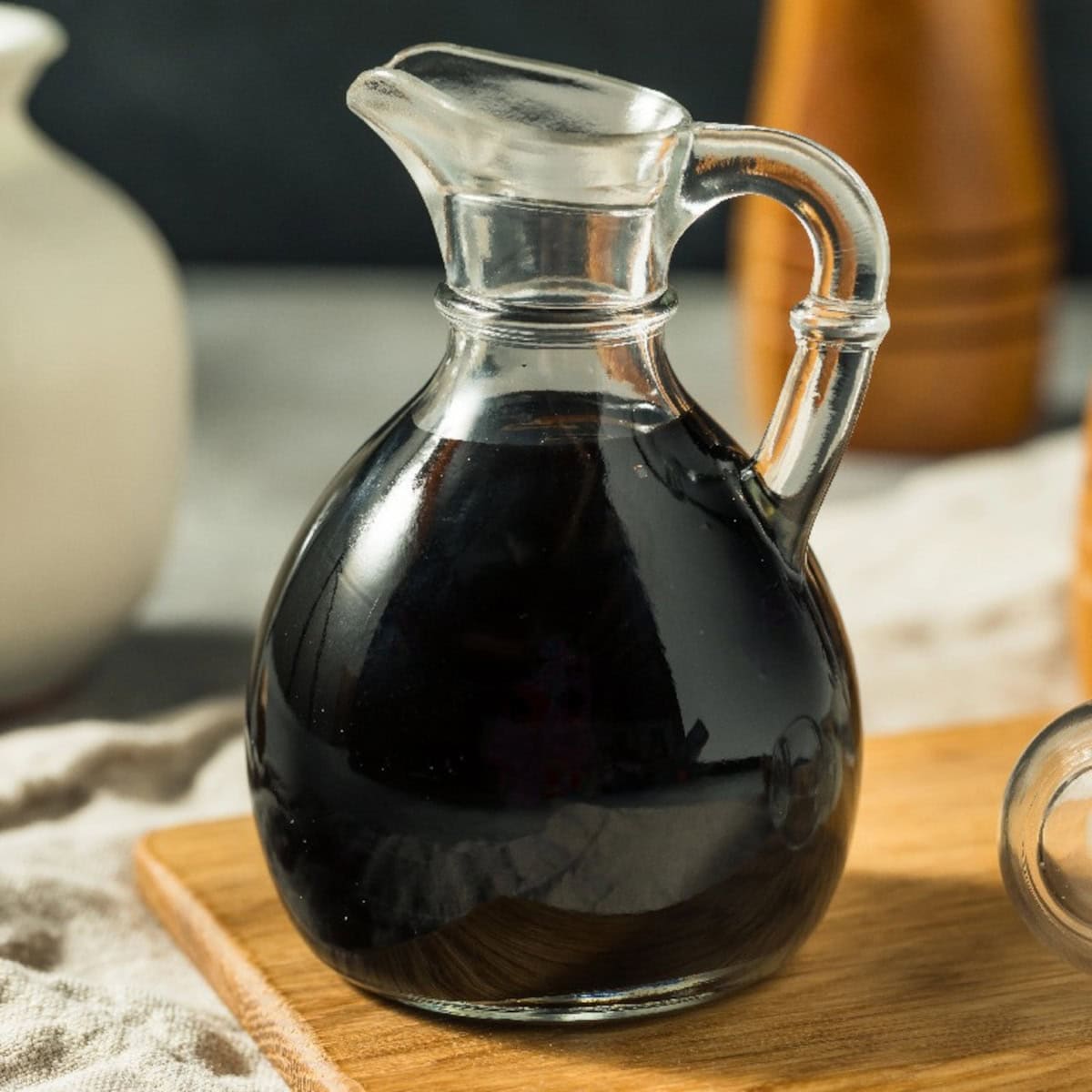Balsamic vinegar glaze in a glass cruet as a Chinese black vinegar substitute.