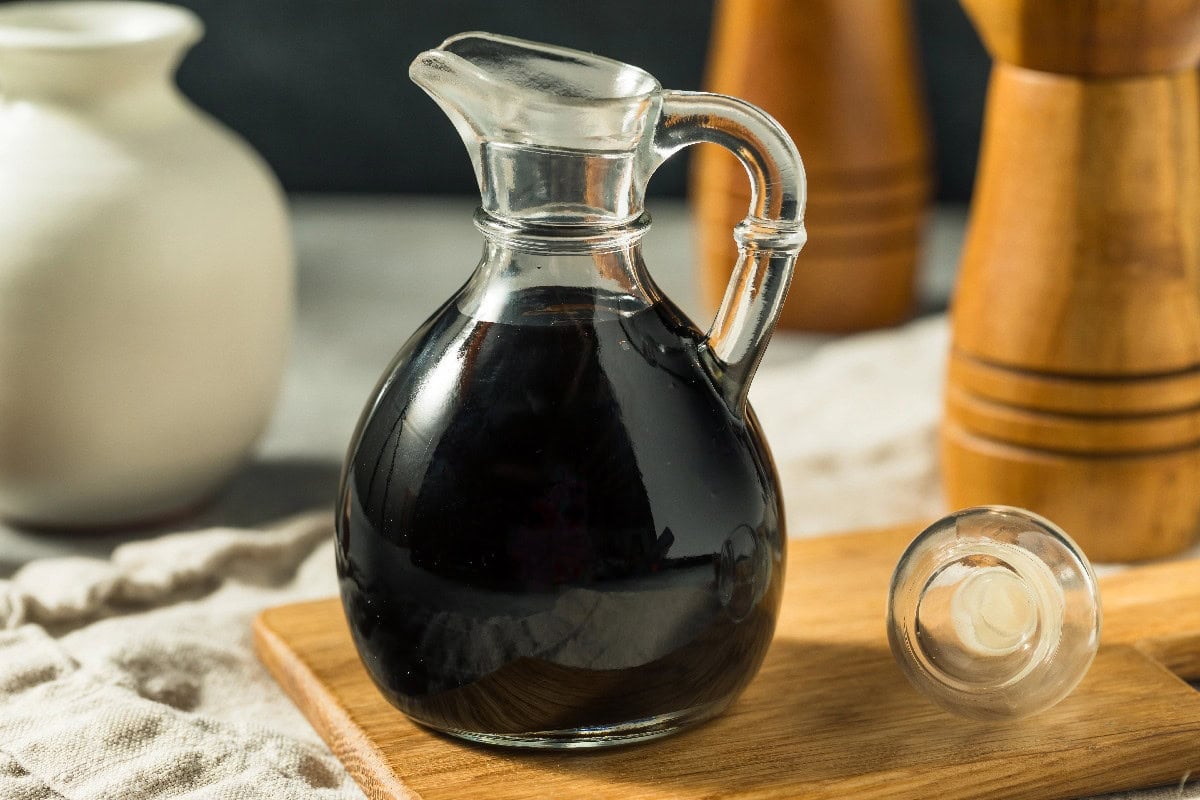 Homemade balsamic vinegar glaze in a glass cruet as a Chinese black vinegar substitute.