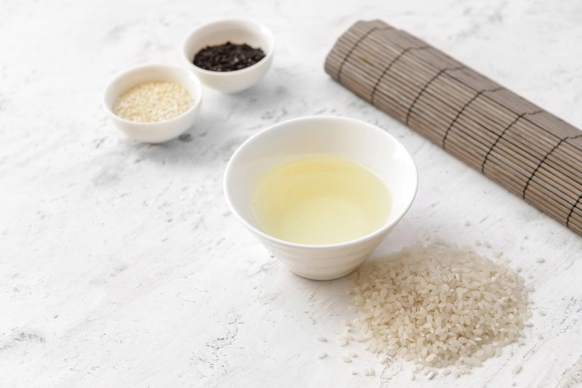 Rice vinegar in a white bowl as a mild Chinese black vinegar substitute.