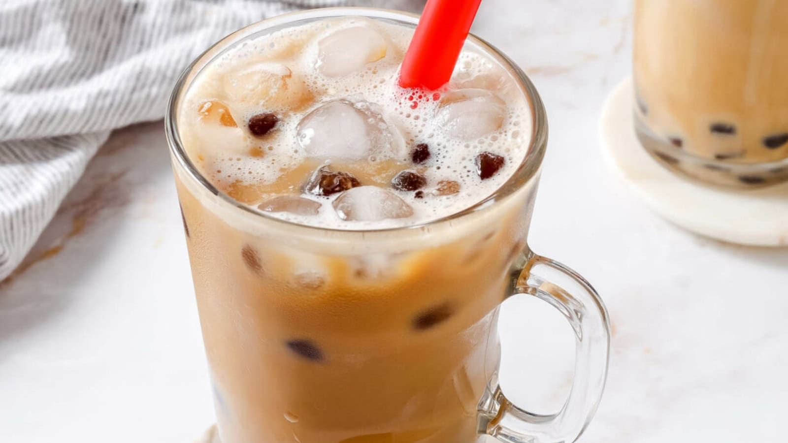 Coffee bubble tea served with milk and chewy boba pearls.