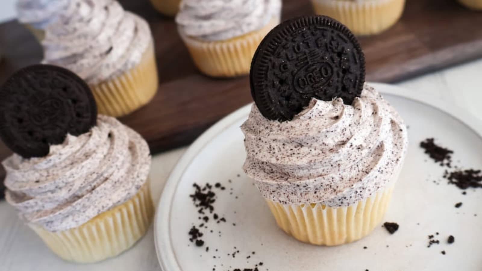 Dairy-free vanilla cupcakes topped with smooth vanilla frosting.