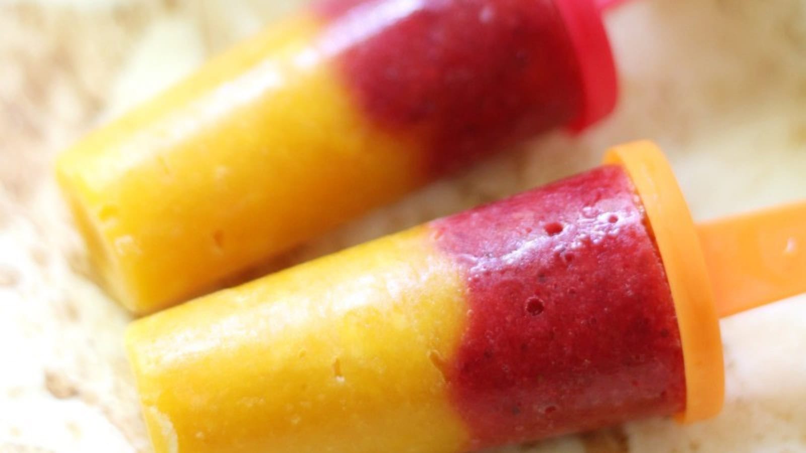 Strawberry mango popsicles made with just two simple ingredients.