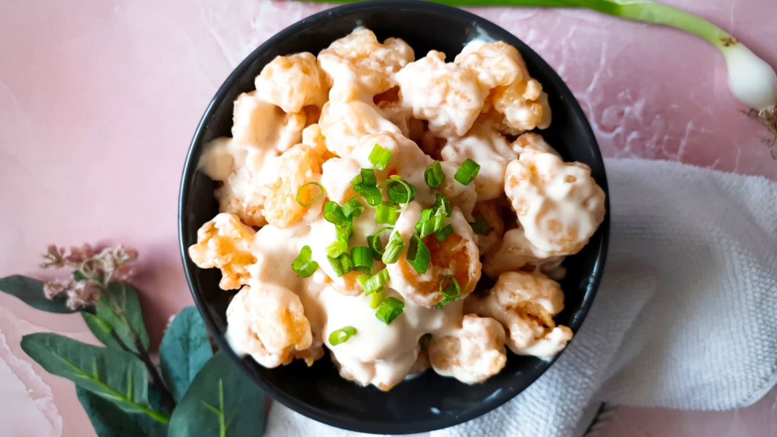 Crispy shrimp coated in a creamy coconut sauce.