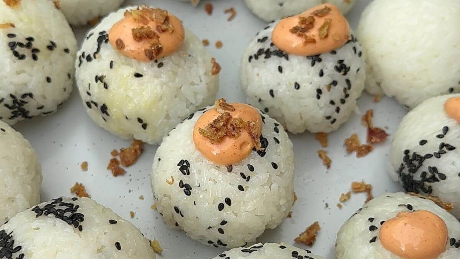 Rice balls filled with spicy tuna and wrapped with seaweed.