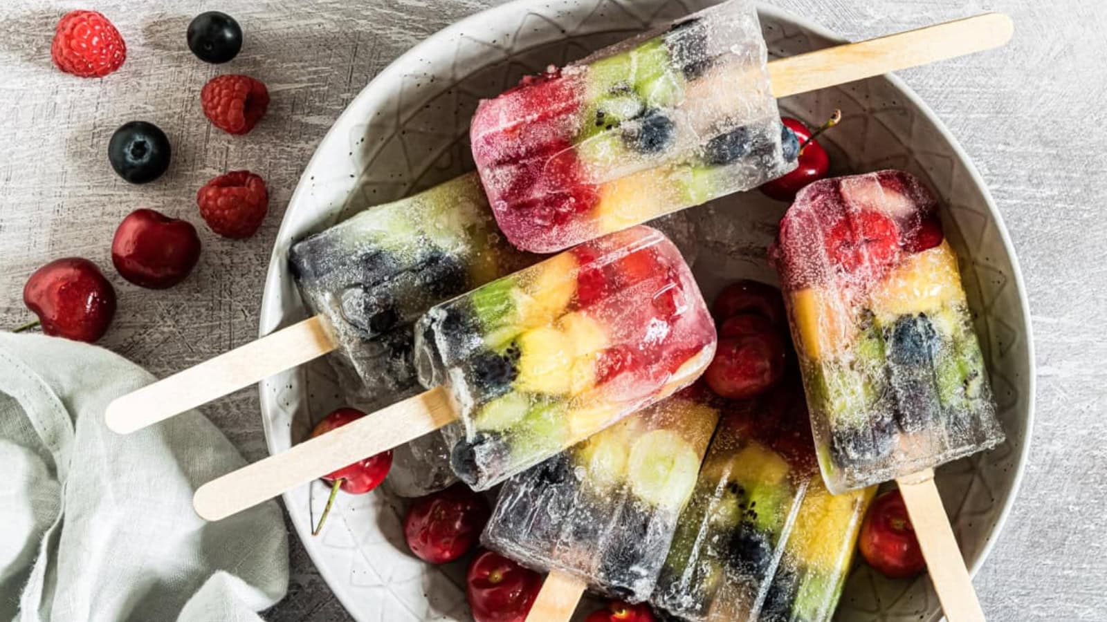 Colorful rainbow popsicles layered with vibrant fruit flavors.