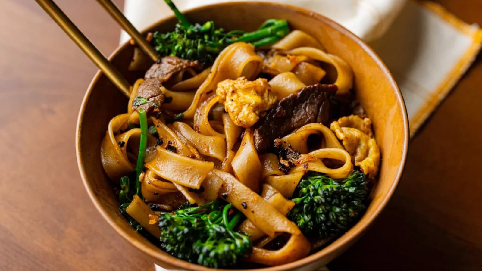 Wide rice noodles stir-fried with elk and vegetables in a savory sauce.