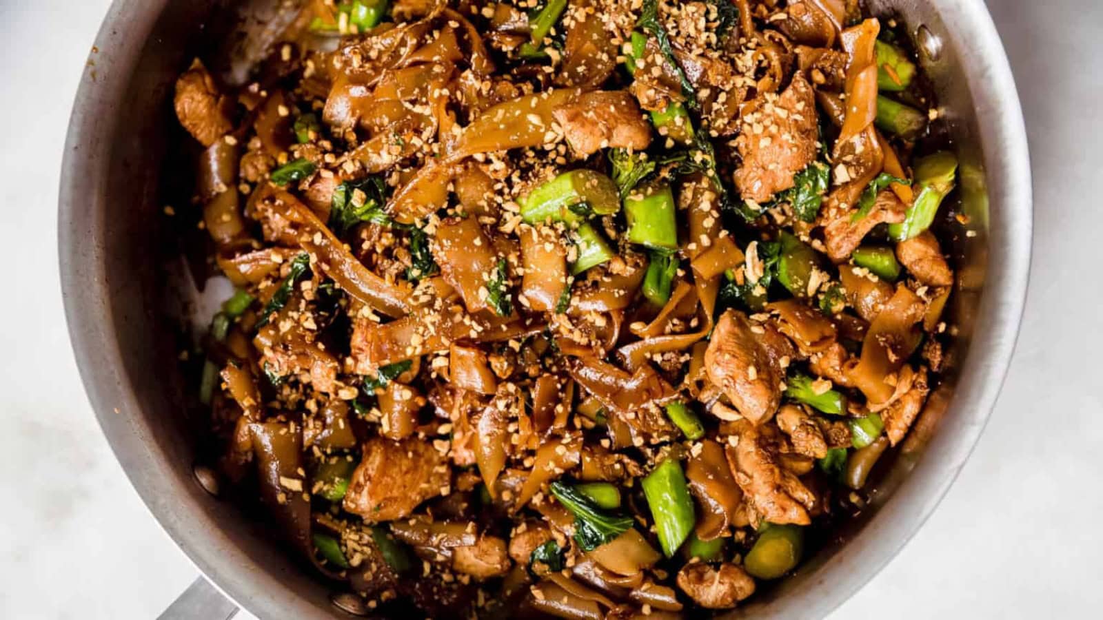 Wide rice noodles stir-fried with vegetables in a rich soy sauce.